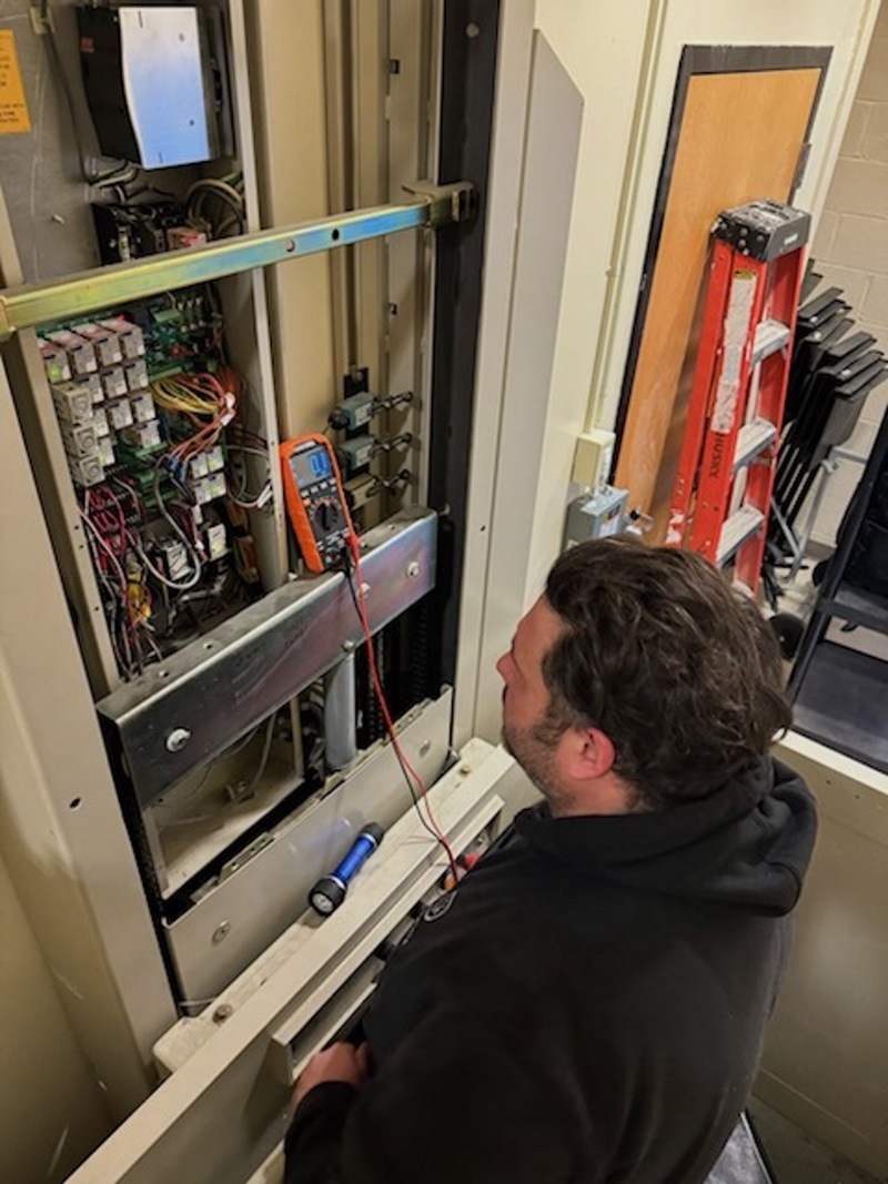 Ferens Elevator Service servicing elevator wiring panel, Poughkeepsie NY